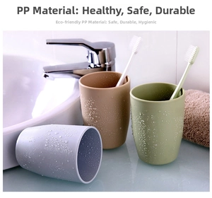 Detail of eco-friendly PP plastic toothbrush cups with water drops in bathroom setting