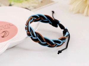 Detail of woven leather bracelet in blue black and brown with adjustable cord closure