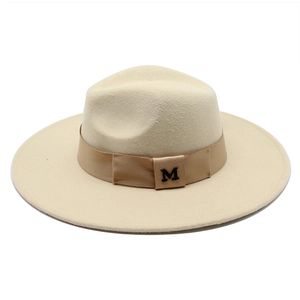Close-up of beige wool fedora hat featuring a satin band and black M letter embroidery