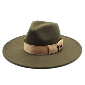 Detail of dark green wool fedora hat with champagne satin band and metal M-letter pin