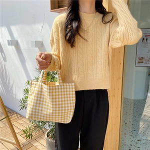 Yellow plaid cotton linen tote bag paired with a mustard knit sweater for a casual look