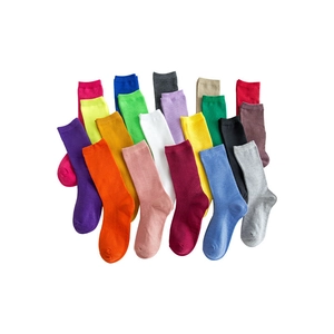 Vibrant cotton crew socks in multiple solid colors spread on a white background