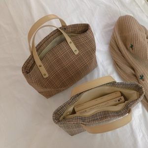 Vintage brown plaid tote bag with faux leather handles and spacious interior shown from above