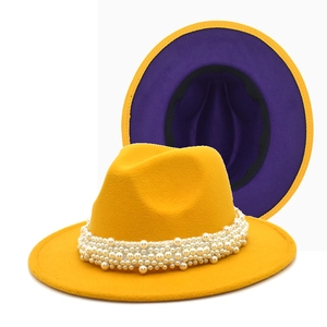Detail of wool fedora with pearl band and contrasting yellow and purple color design