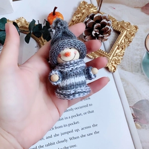 Handcrafted knitted snowman ornament with grey stripes and wooden head for Christmas decor