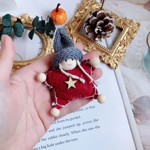Handcrafted red felt star doll ornament with gray knitted hat and wooden accents for Christmas