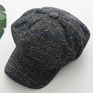 Top view of grey plaid octagonal newsboy cap showing woven texture and wool blend fabric