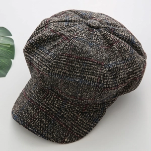 Detail of the brown plaid texture and wool blend fabric on this vintage newsboy cap