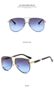 Detail of aviator sunglasses featuring gold metal frames and gray-blue gradient lenses