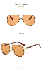 Detail of gold metal pilot sunglasses with brown lenses and hollow mesh design temples