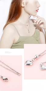 Detail of silver double-layered necklace with heart pendants and bead accents on model