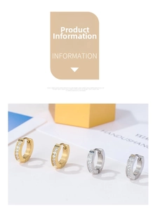 Detail view of gold and silver huggie earrings with round zircon stones in minimalist style