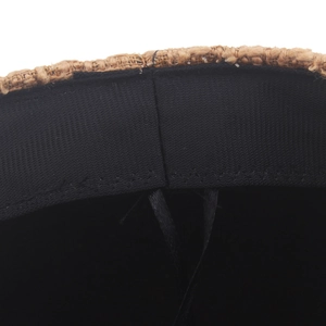 Internal detail of woven navy-style newsboy hat featuring inner sweatband and stitching