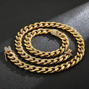 Macro view of gold stainless steel Cuban chain set with pavé rhinestone lobster clasp