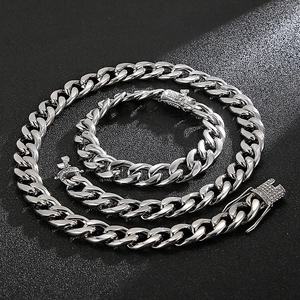 Macro view of silver curb chain set with sparkling rhinestone buckle on dark background