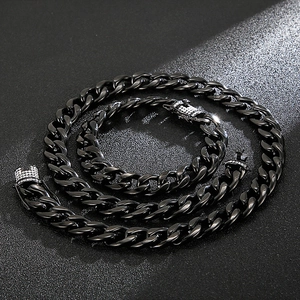 Detail of black Cuban link chain set with sparkling rhinestones on textured background