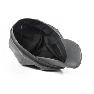 Detailed view of grey leather newsboy cap showing texture and black inner lining