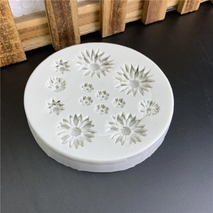 Daisy shaped white silicone mold for DIY cake fondant and resin craft on black background