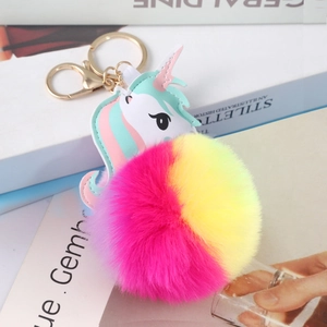 Close-up of a colorful unicorn keychain with soft gradient faux fur and gold metal ring