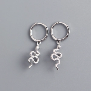 Macro detail of silver S925 sterling silver snake pendant hoop earrings on grey background