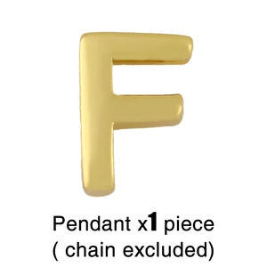 Close-up of polished gold-plated letter F pendant, single piece without chain