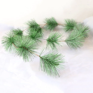 Artificial green pine needle garland for Christmas decoration on white background