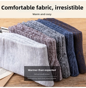 Detailed close-up of thick winter crew socks in assorted solid colors and thermal terry fabric