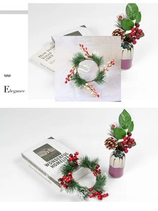 Detail of Christmas wreath with red berries, pine needles, and pine cones in ceramic vase