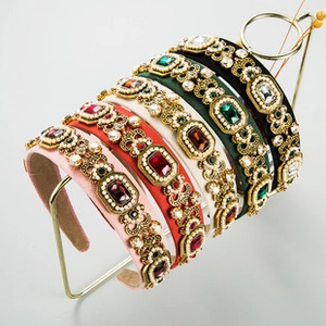 Close-up of velvet headbands featuring baroque crystal and pearl embellishments