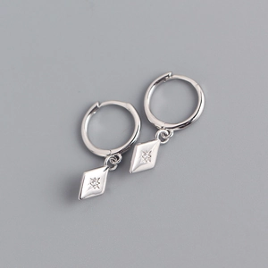 Macro detail of S925 sterling silver hoop earrings with rhombic zircon star pendants