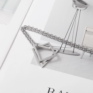 Detailed view of silver double hollow triangle pendants on a stylish O-link chain necklace