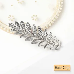 Detail of silver alloy leaf spring clip with clear texture and metallic luster