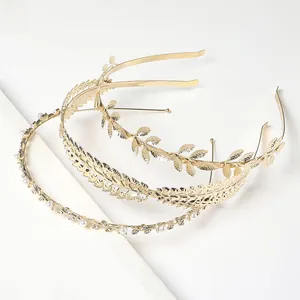 Detailed view of three-piece golden alloy hair accessories with leaf and pearl accents