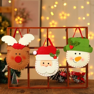 Weihnachtliche Geschenktüten aus Vlies mit Weihnachtsmann auf einem Holzregal
