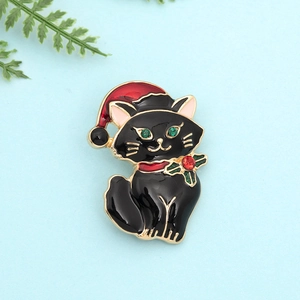 Detailed close-up of a black Christmas cat brooch with red hat and green crystal accents