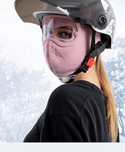Pink fleece balaclava with anti-fog goggles shown in detail against winter snow