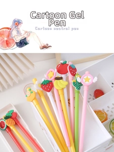 Detailed close-up of cute fruit-themed cartoon pens in a white desk organizer holder