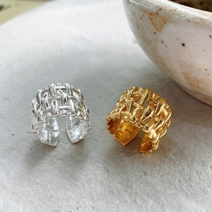 Detailed view of woven bamboo texture on 925 sterling silver open rings in gold and silver