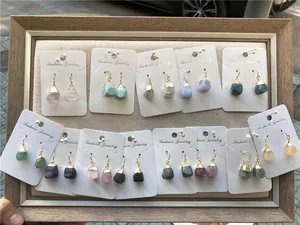 Detailed display of natural gemstone earrings in diverse colors with gold-plated edges