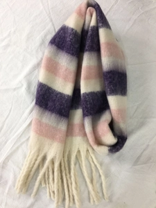 Close-up of soft purple, pink and white striped plush scarf with fringe tassel detail