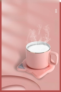 Pink cat-ear warmer base with ceramic mug featuring 55°C digital temperature display