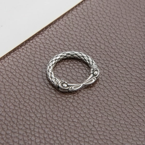 Detailed view of vintage silver ring with textured dragon scale patterns on leather