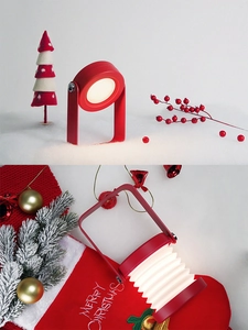 Red portable folding lantern lamp with warm white light in a cozy Christmas setting