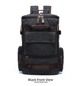 Front view of large canvas travel backpack in black with brown leather accents