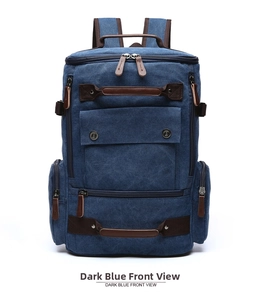 Front view of a dark blue canvas backpack featuring brown leather trim and multiple pockets