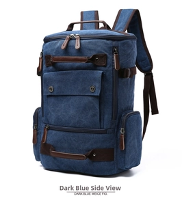 Detail view of large navy canvas backpack with leather reinforcements and side pockets