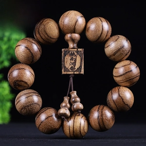 Detail of 20mm agarwood beads with natural grain, square charm, and gourd pendants
