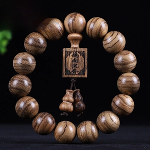 Macro view of Vietnamese agarwood beads with natural grain and square pendant detail