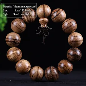 Detailed close-up of Vietnamese agarwood beads showing natural grain and oil lines
