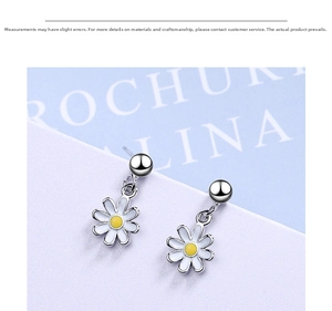 Close-up of small daisy stud earrings with white enamel petals and yellow center